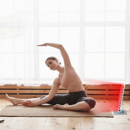 Vrouw doet Yoga vlak voor een werkend tafelmodel roodlicht