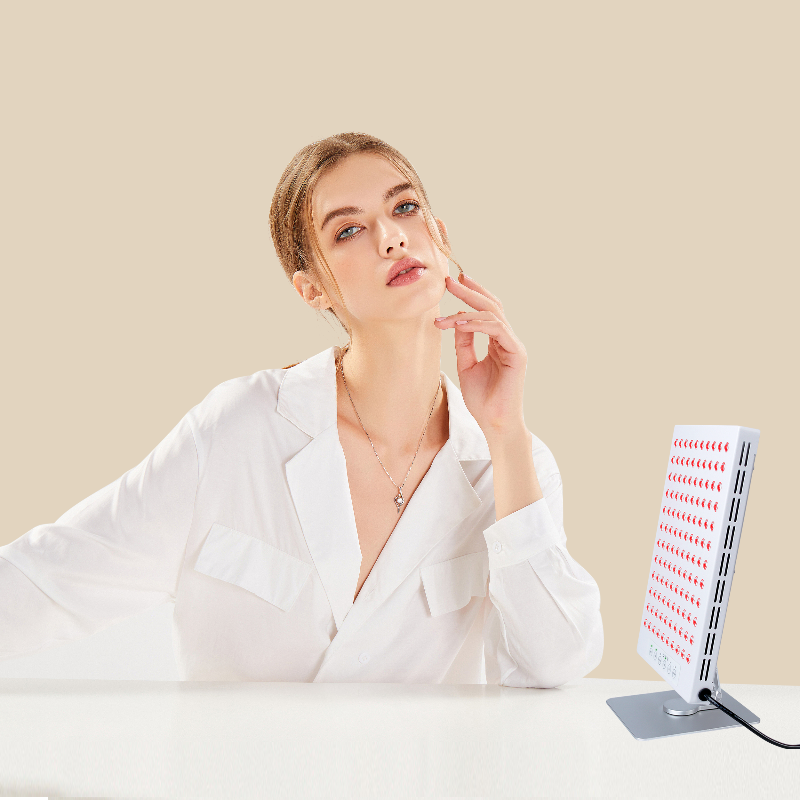 Vrouw zit aan tafel of bureau met tafelmodel voor haar gezicht